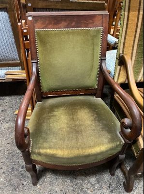 an image of a green chair with a wooden frame and green upholstered seat