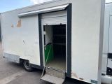 a white truck with a door open in a parking lot