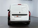 a white van parked in a room with a black floor