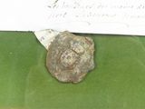 a small piece of metal on a green cloth