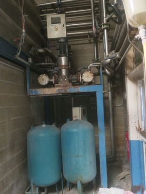 two blue tanks sitting next to each other in a room