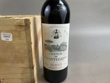 a bottle of wine sitting next to a wooden box