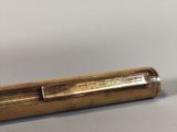 an image of a gold colored pen with a metal cap