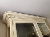a white cabinet with a mirror on top of it