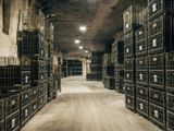 many crates that are lined up in a large room