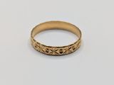 a close up of a gold ring on a white surface