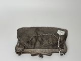an antique silver purse with chain hanging from it ' s side