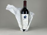 a bottle of wine wrapped in a plastic bag