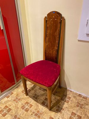 a red chair in the corner of a room