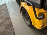 a yellow bus parked on the side of the street