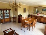 a dining room with a table and chairs and a chandelier