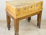 a small wooden table with four drawers on casteors