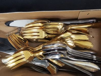 a bunch of forks and knives in a box