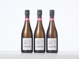 three bottles of wine sitting on top of a table