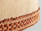 an image of a close up of a lamp shade with a brown trim