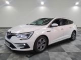 the white car is parked in a large room with checkered floor