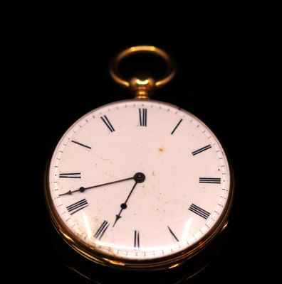 a gold pocket watch with roman numerals on the face