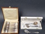 silverware in a box with a spoon and spoon rest in it