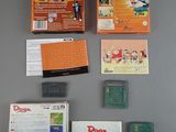 a box of nintendo games on a table next to other items