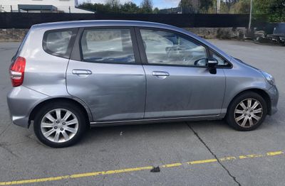 a silver car that is parked in a parking lot
