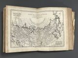 an old book with a map of the world on it