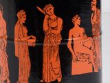 a black and orange vase with a picture of people on it