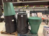trois poubelles noires et vertes posées sur une palette dans un magasin