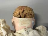 a doll that has a hat on it ' s head