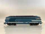 a blue and white train on a white surface