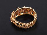 a close up of a gold ring on a black surface