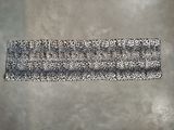 a black and white leopard print headband on a gray background