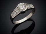 a diamond ring with baguets set in 18k white gold