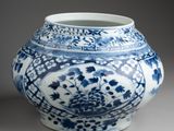 a blue and white vase sitting on a table