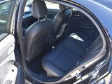 a car with the door open and the passenger seat down