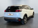 the rear end of a white car parked in a room