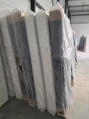 de nombreux matelas emballés dans du plastique dans un entrepôt