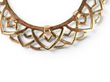 necklace made of gold metal with a geometric design on a white background