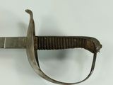 a sword that is on display on a white surface