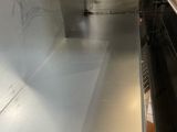 a silver oven that is in the middle of a kitchen