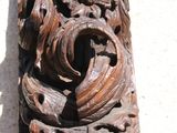 a wooden carving on the wall of a building