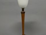 lamp with a wooden base and a frosted glass shade on a gray background