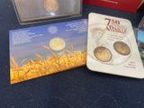 a box of coins sitting on a table next to a book