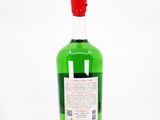 a bottle of green liquid sitting on top of a white surface