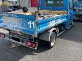 a blue truck that is parked in front of a building