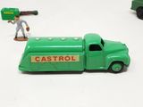 a green toy truck with a baseball player in the back