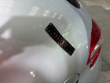 a sticker on the back of a silver car