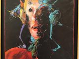 a painting of a woman ' s face is shown in a black frame