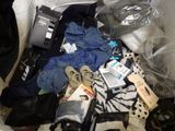 a pile of clothes and other items on the floor