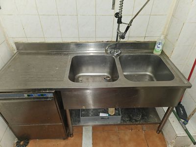 a stainless steel sink with two sinks in it