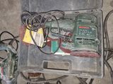 a box with a drill and other tools in it
